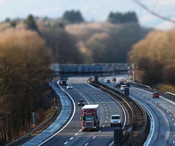 tilt shift, highway, traffic, vehicles, lane, miniature effect, speed, road, to travel, transport, car, driving a car, expressway, roadway, truck, mobility, guard rail, automobile, move, road transport, ride, truck, truck, truck, truck, truck
